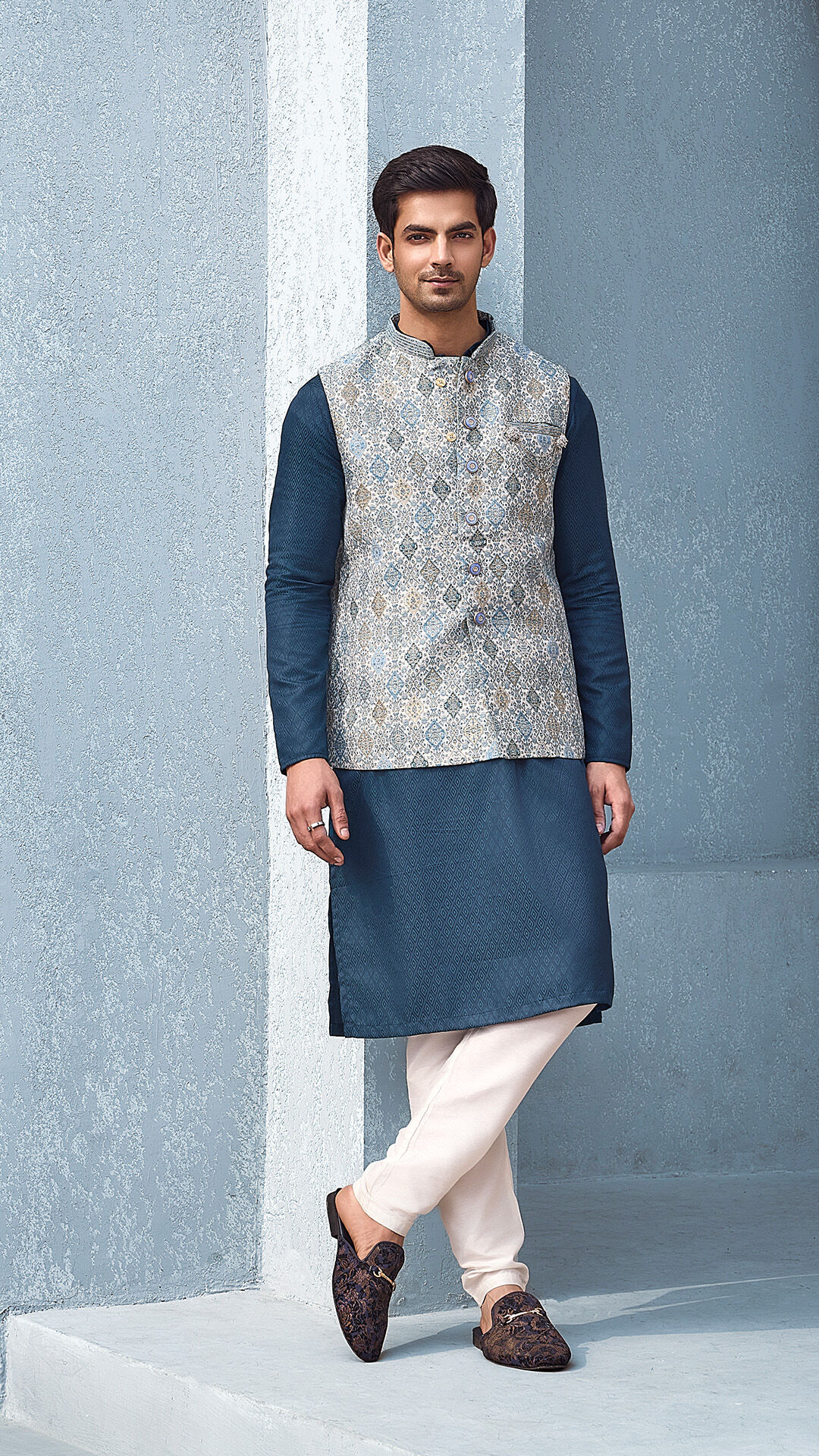 Man wearing a navy blue kurta with designer jacket 